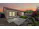 Exterior backyard showcases a covered patio, artificial turf, and rock landscaping at sunset at 2040 N Dome Rock --, Mesa, AZ 85207