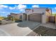 Attractive home showcases well-manicured landscaping, decorative rock, and a brick paver driveway at 2040 N Dome Rock --, Mesa, AZ 85207