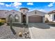 Stunning home features a decorative tower, three car garage, and desert landscaping at 2040 N Dome Rock --, Mesa, AZ 85207