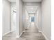 A long hallway with neutral colors and a wood-look tile connects the living space with private bedrooms at 2040 N Dome Rock --, Mesa, AZ 85207