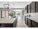 Modern kitchen boasts granite countertops, stainless steel appliances, and stylish pendant lighting over a large island at 2040 N Dome Rock --, Mesa, AZ 85207