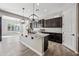 Bright and airy kitchen with an island, dark cabinets, granite countertops, and stainless steel appliances at 2040 N Dome Rock --, Mesa, AZ 85207