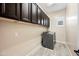 Bright laundry room features upper cabinets, neutral walls, gray tile floor, and stainless steel washer at 2040 N Dome Rock --, Mesa, AZ 85207