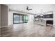 Spacious living room featuring tile floors, sliding glass doors to patio, and an open view into the eat-in kitchen at 2040 N Dome Rock --, Mesa, AZ 85207