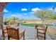 Outdoor lounge area with comfortable seating overlooking manicured landscaping, with mature trees at 2040 N Dome Rock --, Mesa, AZ 85207