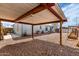 View of backyard with gravel, metal awning and home at 2145 N Silverton St, Mesa, AZ 85203