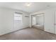 The cozy bedroom includes carpet flooring, a closet, and a large window at 2145 N Silverton St, Mesa, AZ 85203