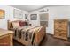 Cozy bedroom featuring a wood frame bed, light walls and natural light at 2145 N Silverton St, Mesa, AZ 85203