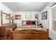 Comfortable bedroom with light-colored walls, wood bed frame, and dresser at 2145 N Silverton St, Mesa, AZ 85203