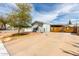 Cozy single-story home featuring a spacious driveway and a charming, well-maintained front yard with a mature tree at 2145 N Silverton St, Mesa, AZ 85203