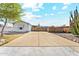 Exterior view of the home's front with a concrete driveway and wooden fence at 2145 N Silverton St, Mesa, AZ 85203