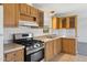 The kitchen includes wood cabinets, stainless appliances and light countertop at 2145 N Silverton St, Mesa, AZ 85203