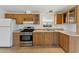 Traditional kitchen with wood cabinets, stainless steel appliances and tiled floors at 2145 N Silverton St, Mesa, AZ 85203