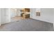 A spacious living room features plush carpet, white walls and views into kitchen at 2145 N Silverton St, Mesa, AZ 85203