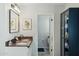 Bathroom with a double sink vanity, decorative mirror, and an adjacent toilet room at 2405 E Balboa Dr, Tempe, AZ 85282