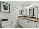 Bathroom showcasing a dual sink vanity with granite countertops, neutral walls, and decorative accents at 2405 E Balboa Dr, Tempe, AZ 85282