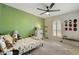 bedroom with a ceiling fan, a sunny window with shutters, and dinosaur themed bedding at 2405 E Balboa Dr, Tempe, AZ 85282