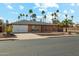 Charming single-story brick home with a well-maintained front yard, palm trees and attached garage at 2405 E Balboa Dr, Tempe, AZ 85282