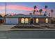 Charming brick home with three arched windows, a two car garage, and desert landscaping at 2405 E Balboa Dr, Tempe, AZ 85282