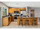 Well-lit kitchen featuring stainless steel appliances, bar stool seating and granite countertops at 2405 E Balboa Dr, Tempe, AZ 85282