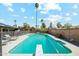 Sparkling pool features diving board, lounge chairs, fenced perimeter and well-maintained landscaping at 2405 E Balboa Dr, Tempe, AZ 85282
