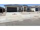 Attractive single-story home with stone accents, a well-maintained gravel front yard, and a paved driveway at 25180 N 159Th Dr, Surprise, AZ 85387