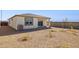Backyard featuring desert landscaping, covered patio, and a block wall for privacy at 25356 W Sunland Ave, Buckeye, AZ 85326