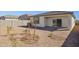 Desert landscaping, patio, and privacy wall in the backyard at 25356 W Sunland Ave, Buckeye, AZ 85326