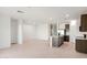 Open-concept living room featuring recessed lighting, tile floors, and an adjacent kitchen with island at 25356 W Sunland Ave, Buckeye, AZ 85326