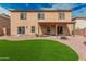 Expansive backyard features an outdoor living space with a wood-burning fireplace and artificial turf at 3239 E San Manuel Rd, San Tan Valley, AZ 85143