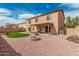 Large backyard with covered patio, brick fire pit, and artificial turf for outdoor entertaining at 3239 E San Manuel Rd, San Tan Valley, AZ 85143