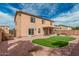 Spacious backyard with a small patch of artificial turf and a covered patio for relaxing at 3239 E San Manuel Rd, San Tan Valley, AZ 85143