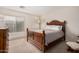 Cozy bedroom with a wooden bed frame and a bright window at 3239 E San Manuel Rd, San Tan Valley, AZ 85143