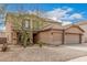 Close up on a two-story home with a three-car garage and desert landscaping at 3239 E San Manuel Rd, San Tan Valley, AZ 85143