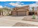 Two-story home featuring a terracotta tile roof, three-car garage, and low-maintenance desert landscaping at 3239 E San Manuel Rd, San Tan Valley, AZ 85143