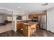 Well-lit kitchen with stainless steel appliances, wood cabinets, and a breakfast bar with seating at 3239 E San Manuel Rd, San Tan Valley, AZ 85143