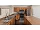 Spacious kitchen showcasing stainless steel appliances, wood cabinets, and a convenient center island at 3239 E San Manuel Rd, San Tan Valley, AZ 85143