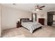 Large main bedroom featuring a ceiling fan, plush carpeting, and ample natural light at 3239 E San Manuel Rd, San Tan Valley, AZ 85143