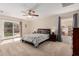 Bright bedroom with a ceiling fan, sliding glass doors to the backyard, and neutral carpeting at 3239 E San Manuel Rd, San Tan Valley, AZ 85143