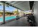 Covered patio area with pool views, seating, and outdoor amenities at 3340 W Ironwood Dr, Phoenix, AZ 85051