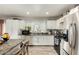 Well-lit kitchen featuring white cabinetry and stainless steel appliances at 3340 W Ironwood Dr, Phoenix, AZ 85051