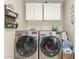 Modern laundry room with front loading washer and dryer, plus wall mounted wire organizers at 3340 W Ironwood Dr, Phoenix, AZ 85051