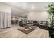 Bright living room featuring a large gray sofa and glass table at 3340 W Ironwood Dr, Phoenix, AZ 85051