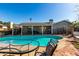 Backyard pool with patio seating and lush landscaping at 3340 W Ironwood Dr, Phoenix, AZ 85051