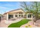 An expansive backyard with an extended covered patio and lush landscaping at 3767 N 162Nd Ln, Goodyear, AZ 85395