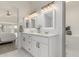 Bathroom showcasing dual sinks, white cabinetry, and modern fixtures at 3872 S Seton Ave, Gilbert, AZ 85297