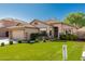 Charming single-story home featuring a well-manicured lawn and desert landscaping for added curb appeal at 3872 S Seton Ave, Gilbert, AZ 85297