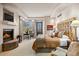 Spacious bedroom with a fireplace, ensuite bathroom, and bright lighting at 40635 N 109Th Pl, Scottsdale, AZ 85262