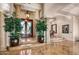 Grand foyer entrance with marble floors, decorative columns, elegant light fixture, and a glimpse of the dining room at 40635 N 109Th Pl, Scottsdale, AZ 85262