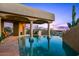 Inviting infinity pool overlooking the property with an evening sunset at 40635 N 109Th Pl, Scottsdale, AZ 85262